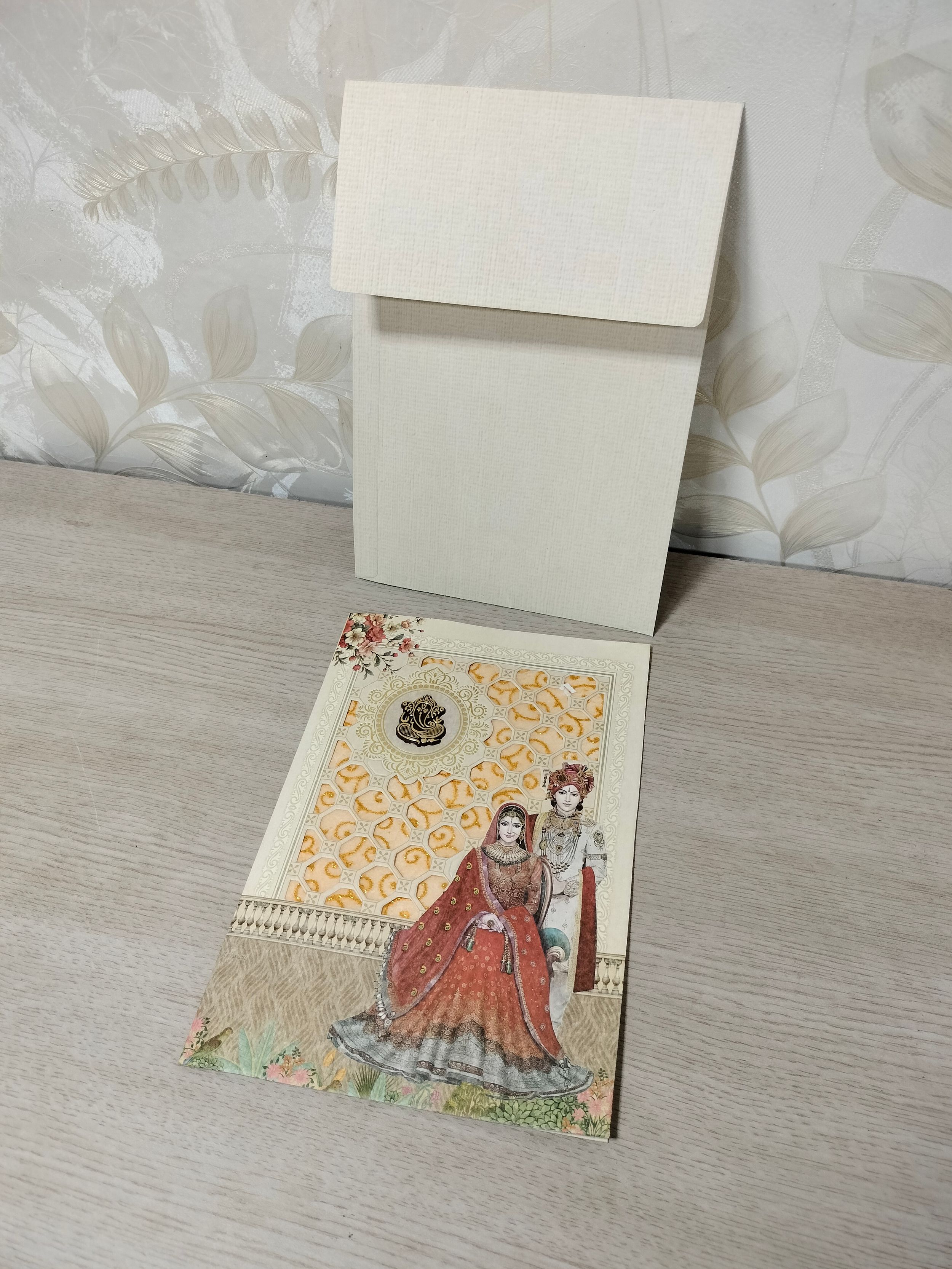 Off White Botanical Wedding Invitation Card with Golden Ganesha Motif (313072) — photo 1