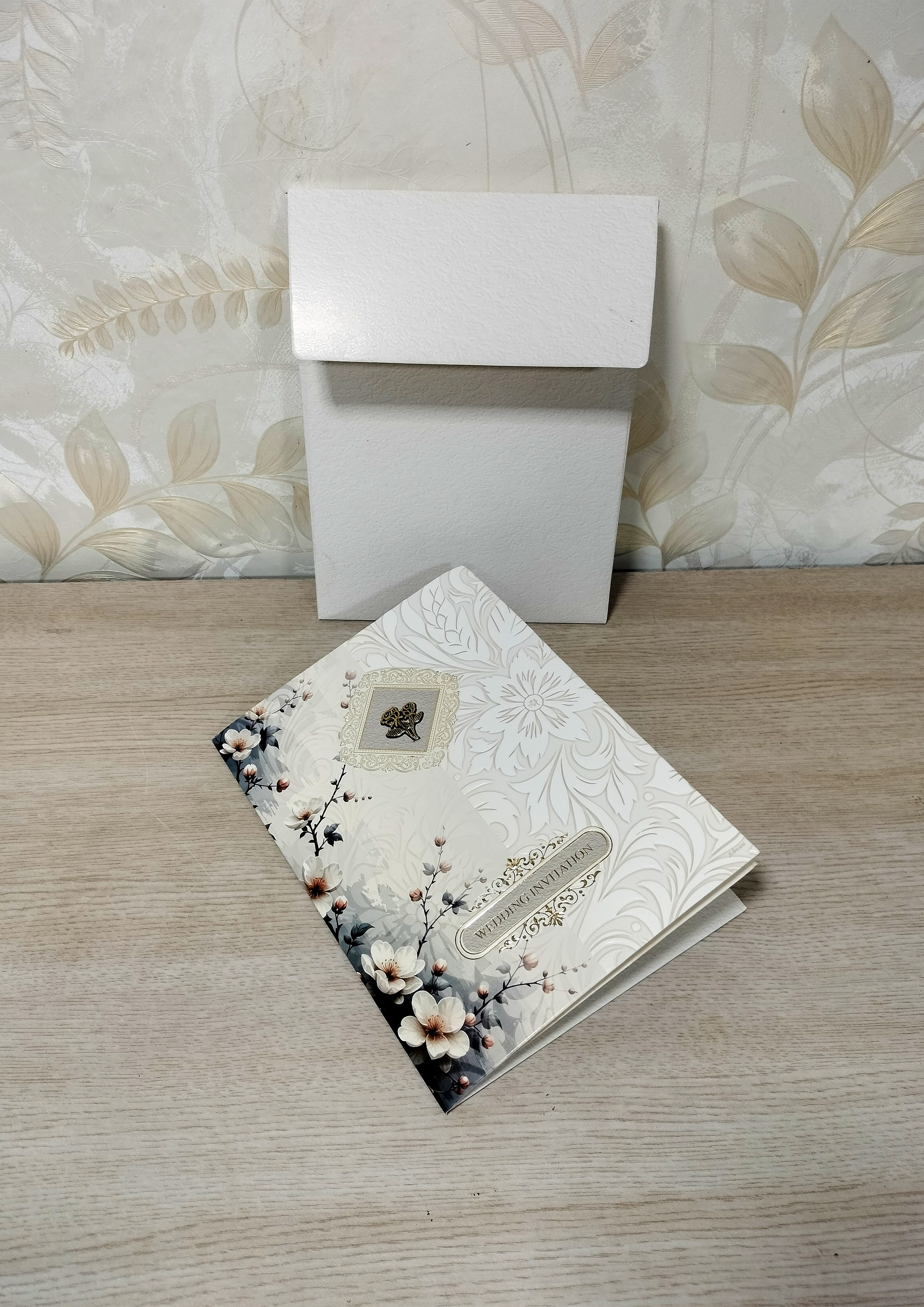 Off-White Wedding Invitation Card with Floral Artwork and Gold Emblem (313082) — photo 1