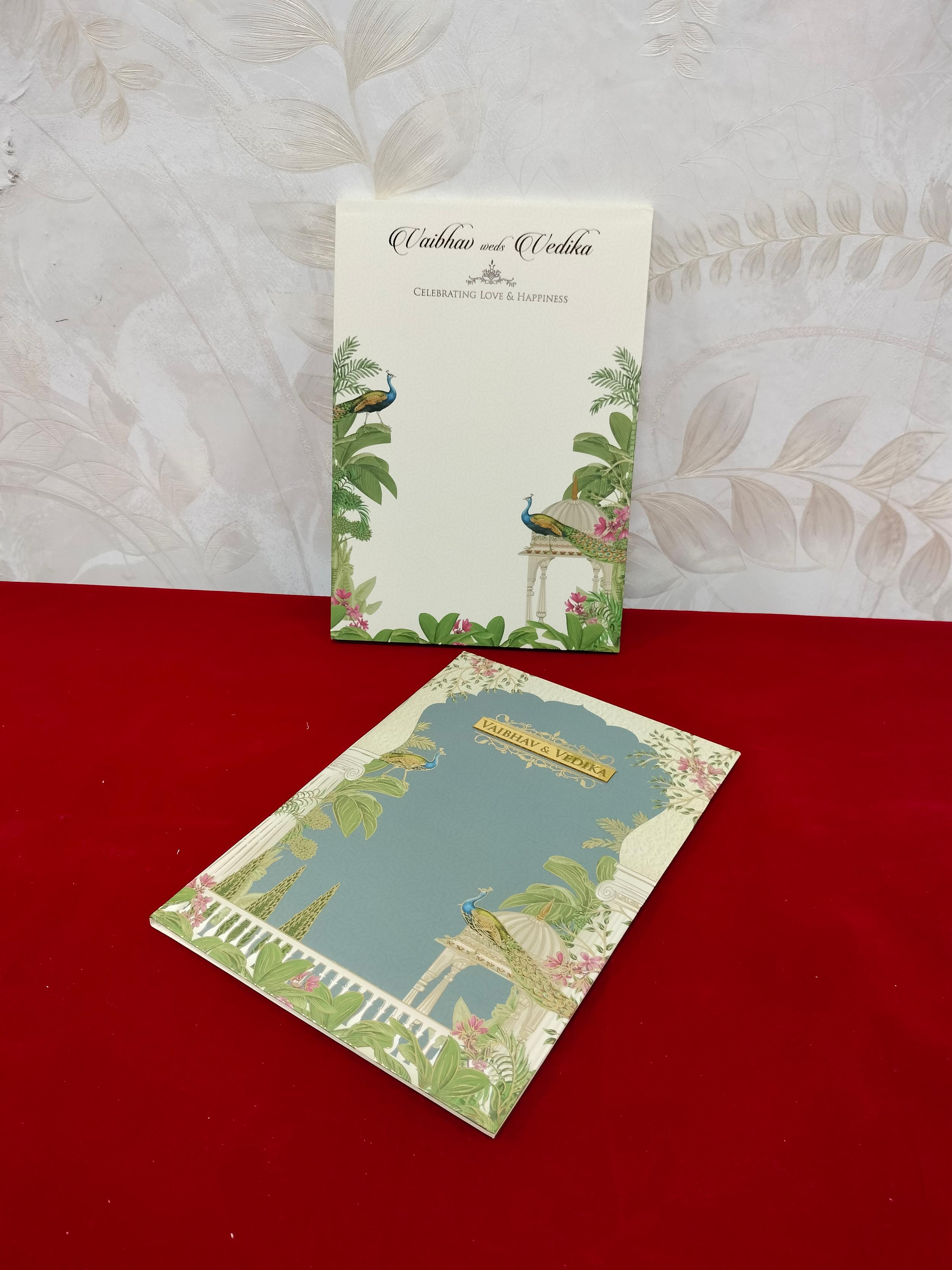 Pastel Blue Peacock Theme Wedding Invitation Card with Golden Floral and Royal Garden Design (3302)